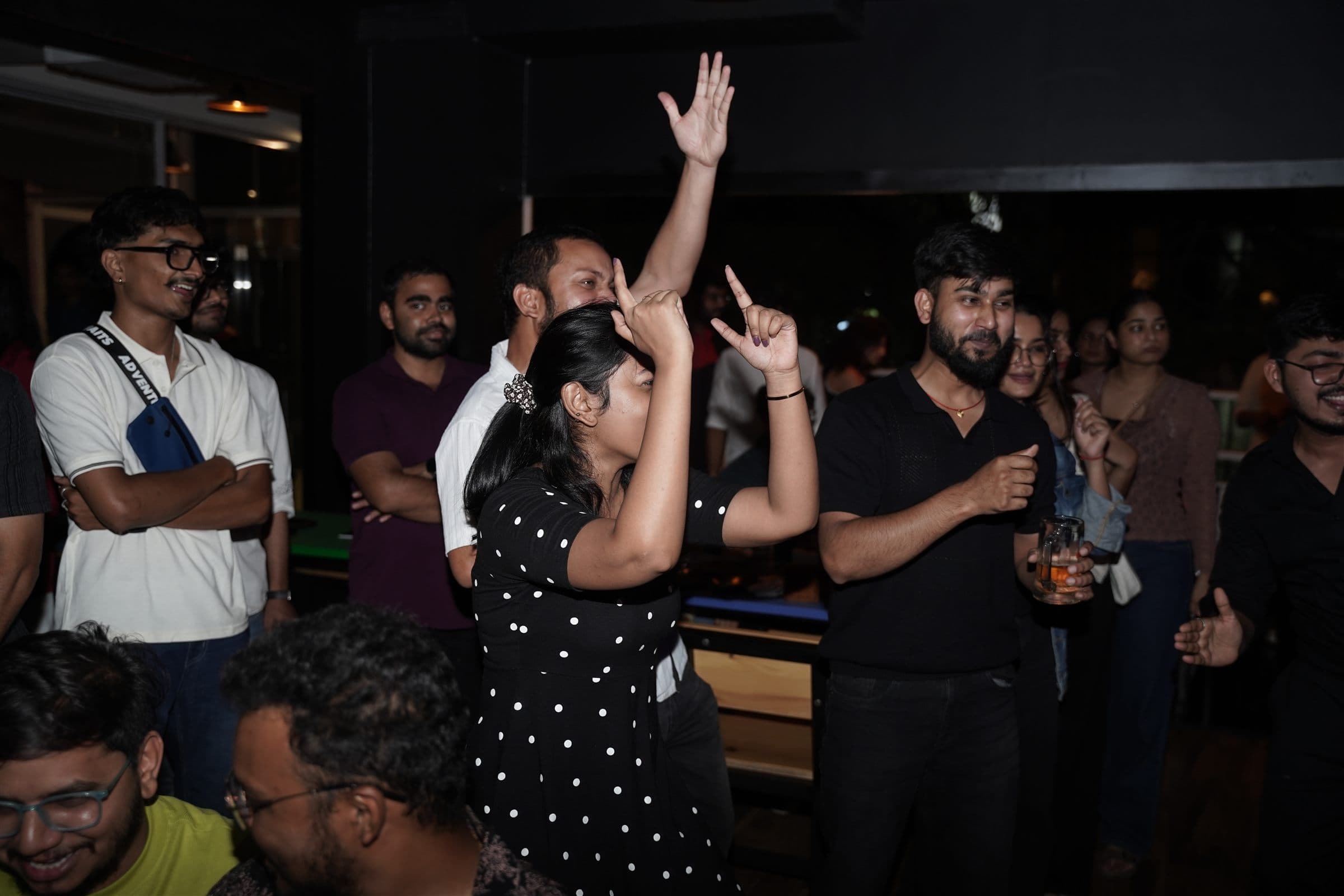 Crowd dancing with hands up at a Malhar live show