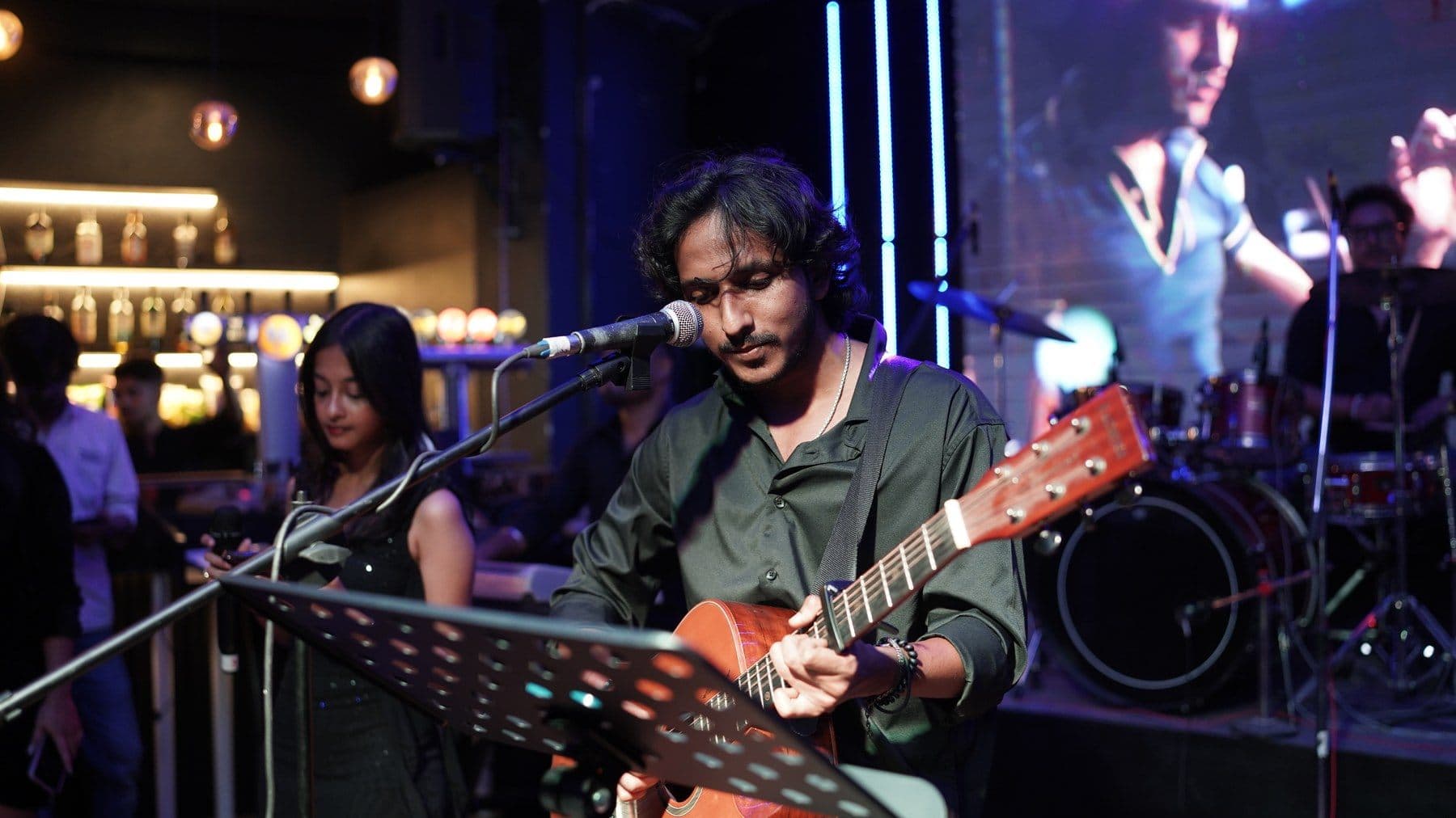 Malhar guitarist performing at a club