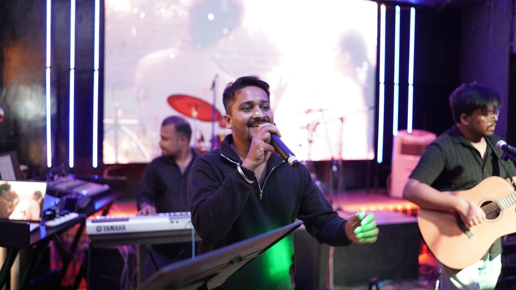 Malhar singer performing at a club
