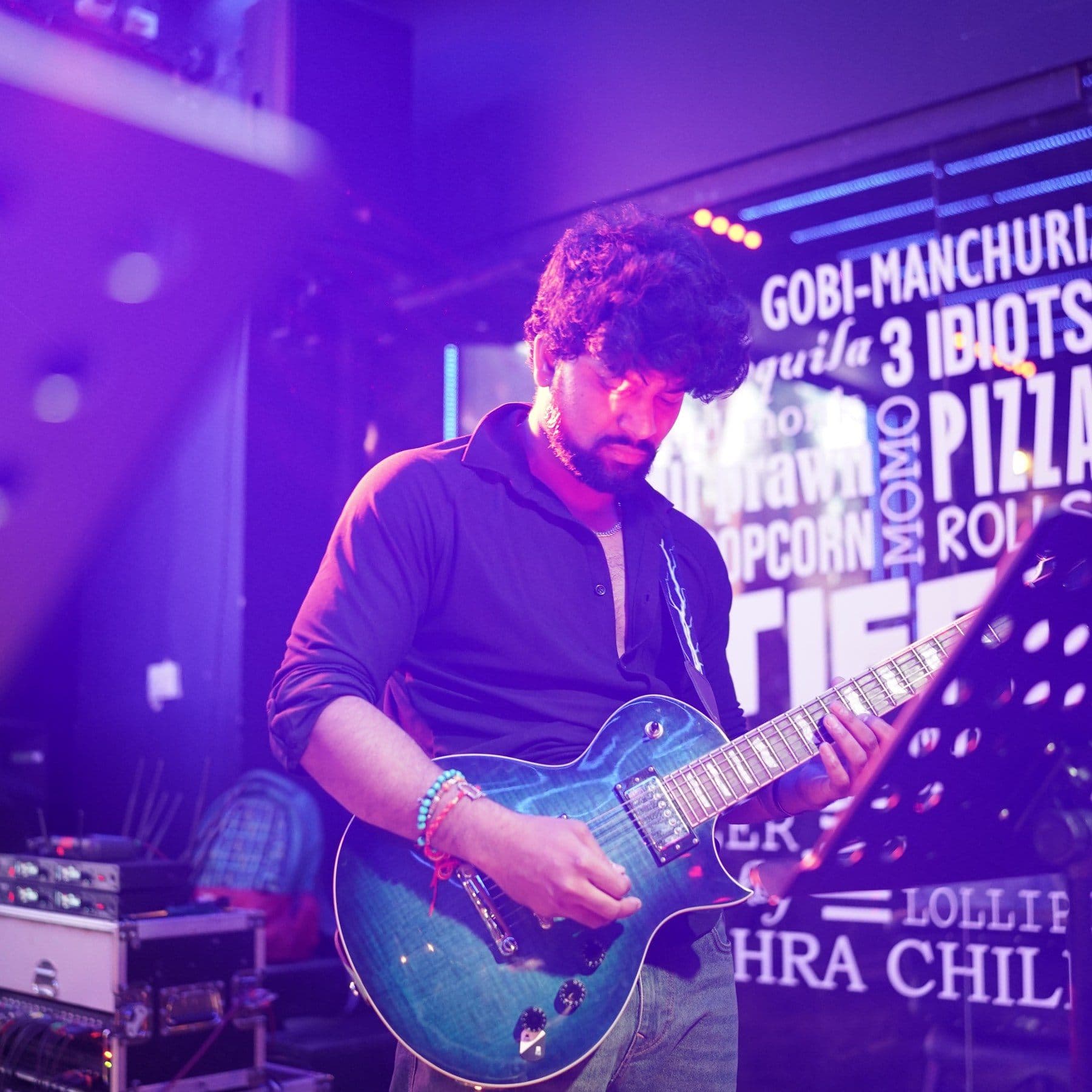 Malhar guitarist performing at a cafe