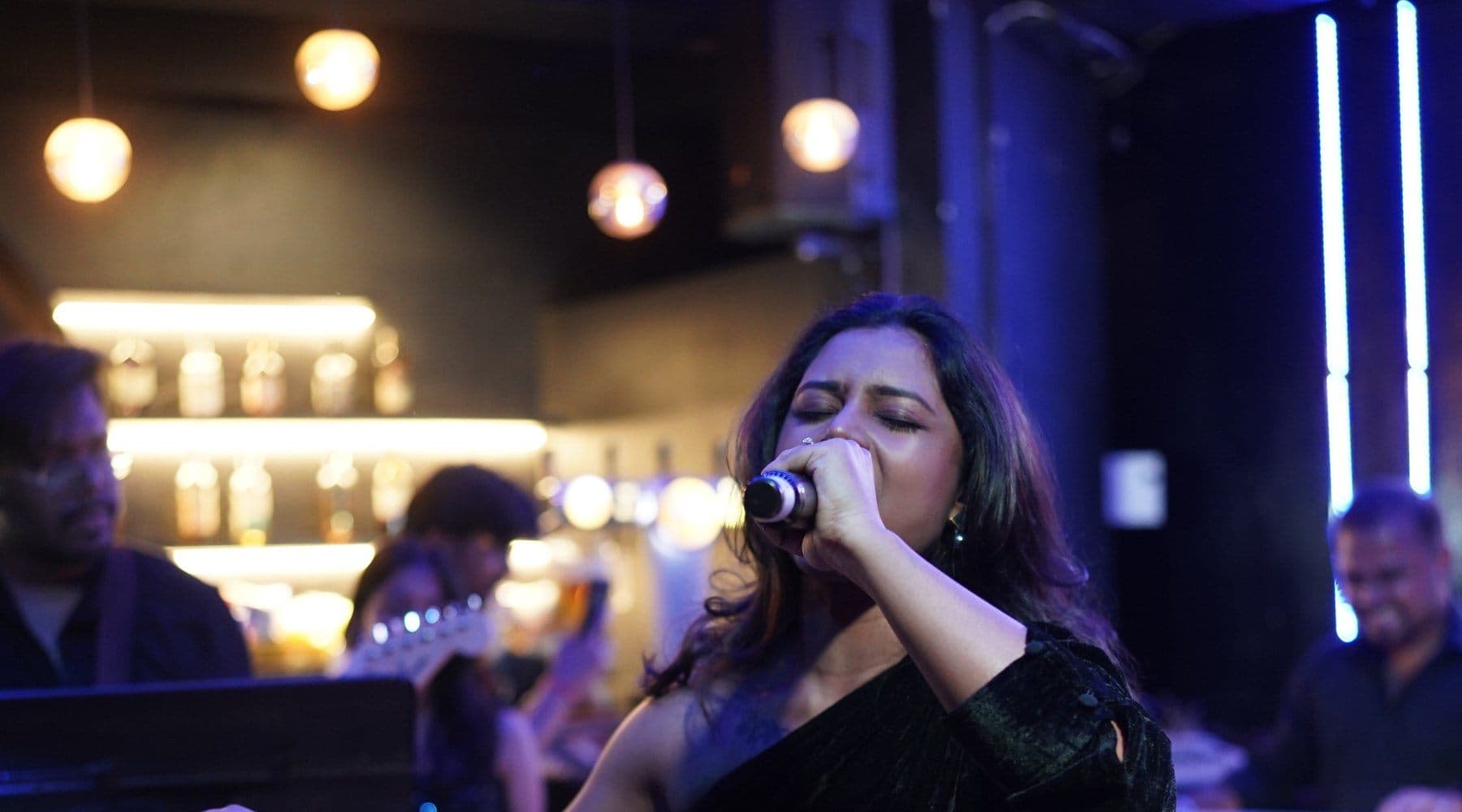 Malhar vocalist singing at a club show